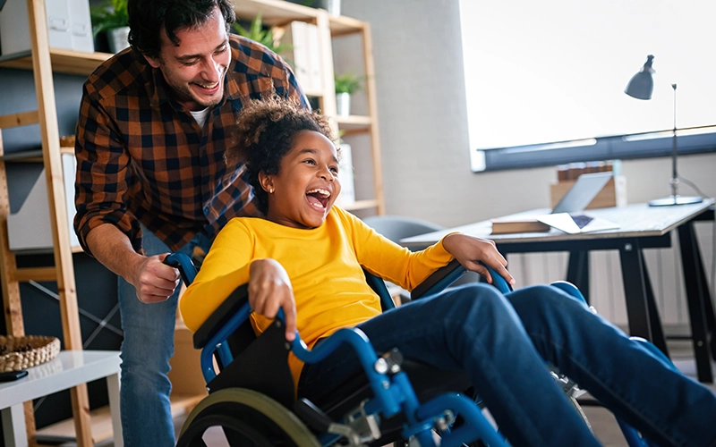 smiling young girl in a wheelchair