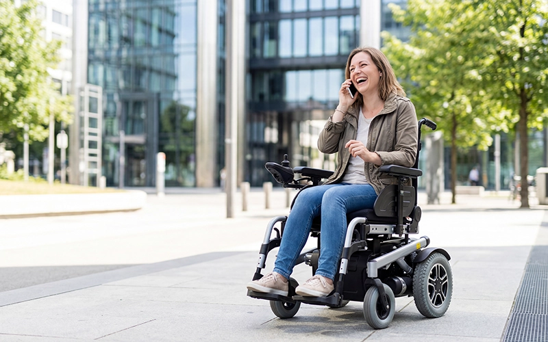 woman outdoors in a power wheelchair