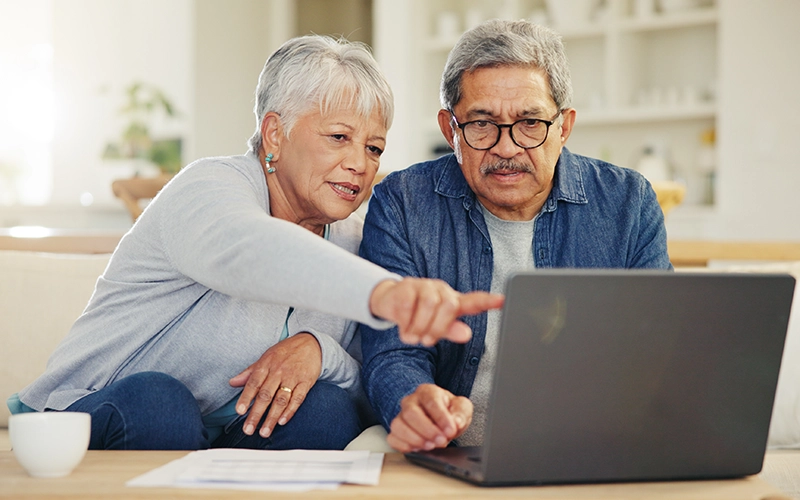 man and woman looking at a laptop